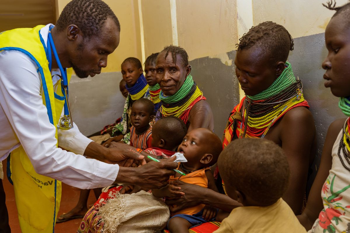 Daniel Ereng, a nurse at Sopel dispensary, feeds Ekerip Ekaal, 11 months.Kenya