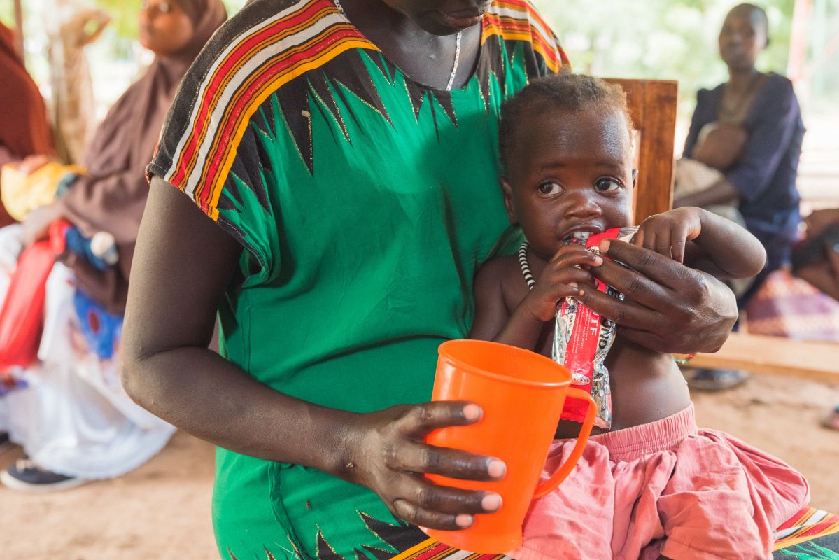 Sabina Naboi, mother to Analia Wally, feeding her daughter RUTF therapeutic food.Kenya