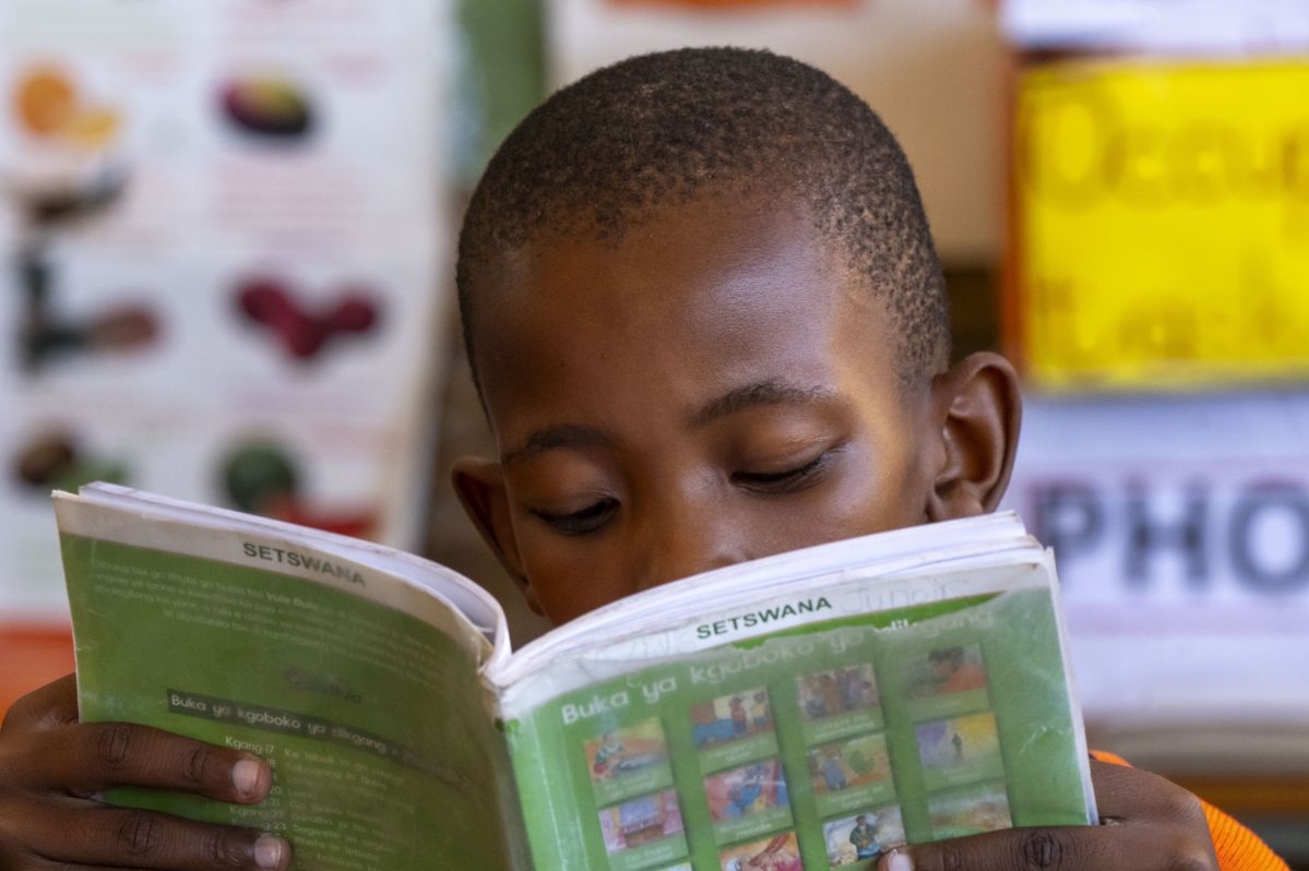 A boy reading a Setswana (Local language) book