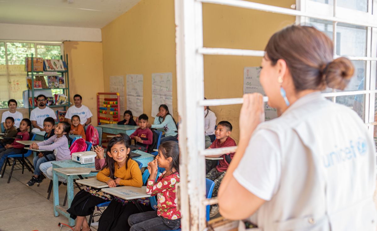 UNICEF staff overlooking classroom
