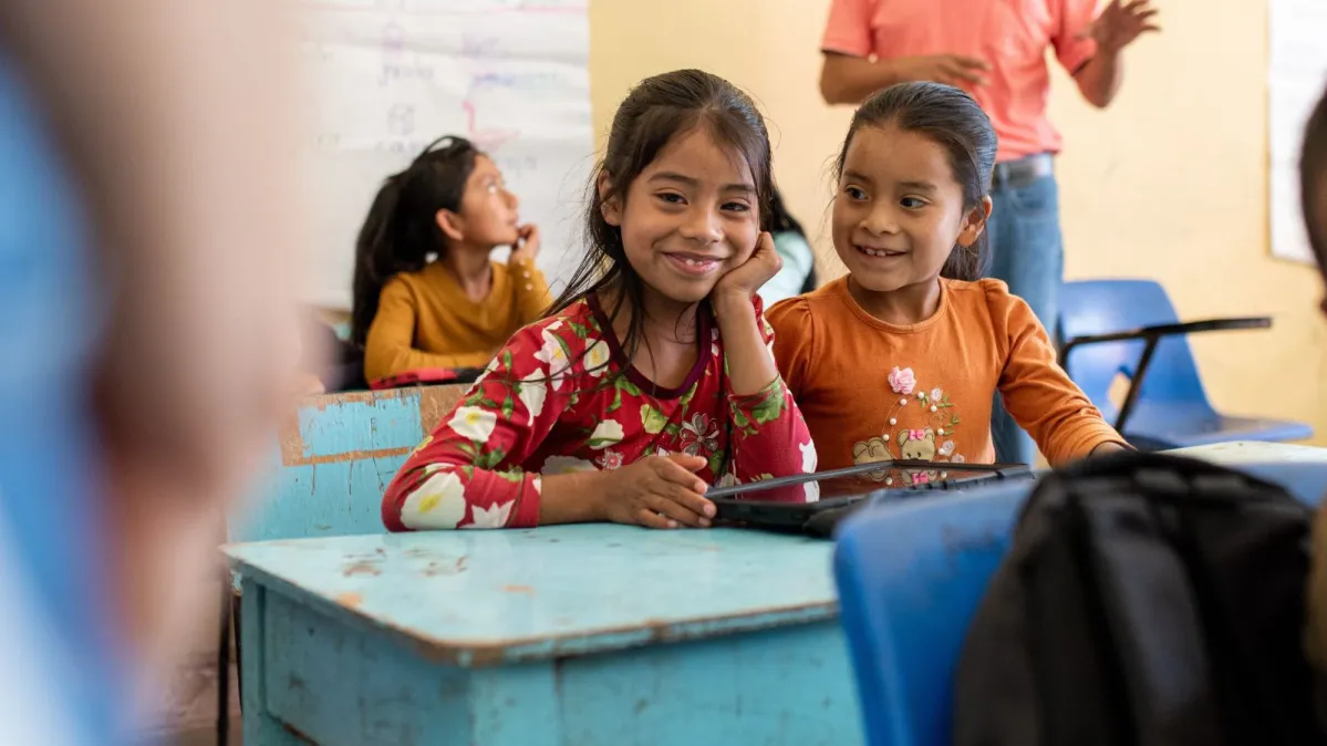 Girls in classroom smiling