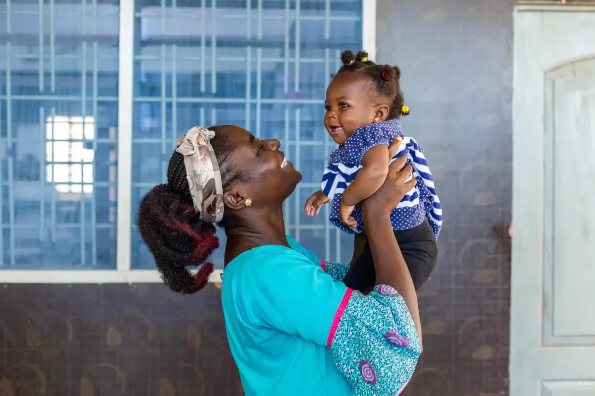 UNICEF staff holding baby