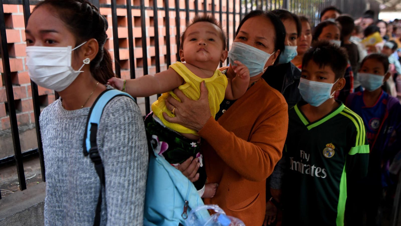 People wear face masks as they wait to enter a children's hospital in Phnom Penh on January 30, 2020