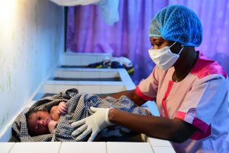 children-medical-worker-care: © UNICEF/UNI325620/Frank Dejongh