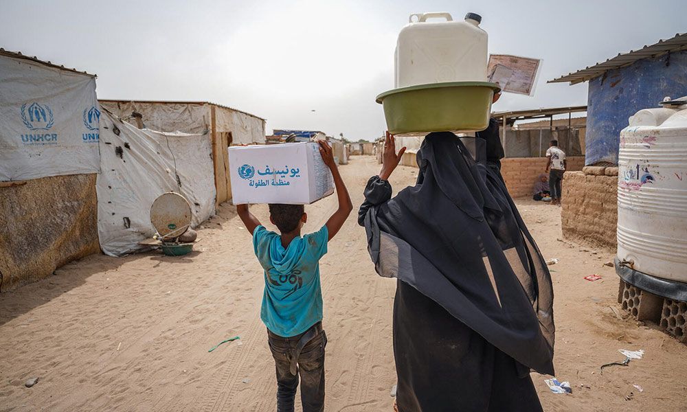 Osamah Amaar, 11, and Hanan Abdo, 32, are displaced from Al Hudaydah and live in Ash-Sha’ab IDP Camp, in Yemen. They just received an RRM kit. 