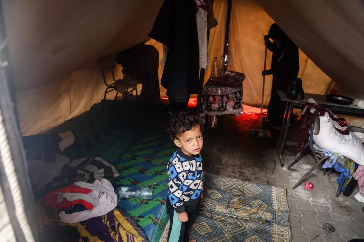 Amir Farhan, a 5-year-old, stays in a tent with his family in a shelter center in Khan Younis