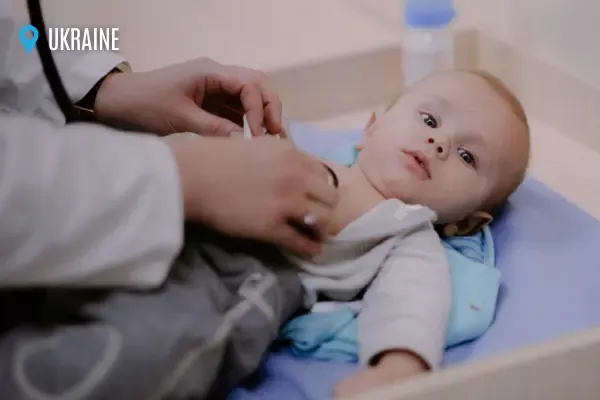 A baby is being examined by a doctor