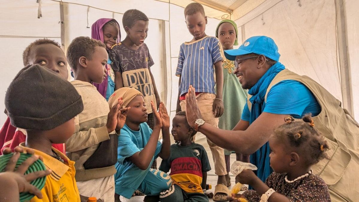 A UNICEF worker plays with children at a safe space we set up in Tiné, eastern Chad. UNICEF is on the ground providing life-saving care — from food and clean water to medical help, protection, and education — so children can be safe, healthy, and have a chance to learn and grow again.